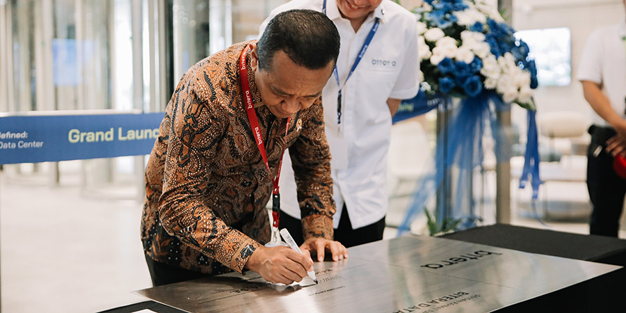 A person signing a document  Description automatically generated